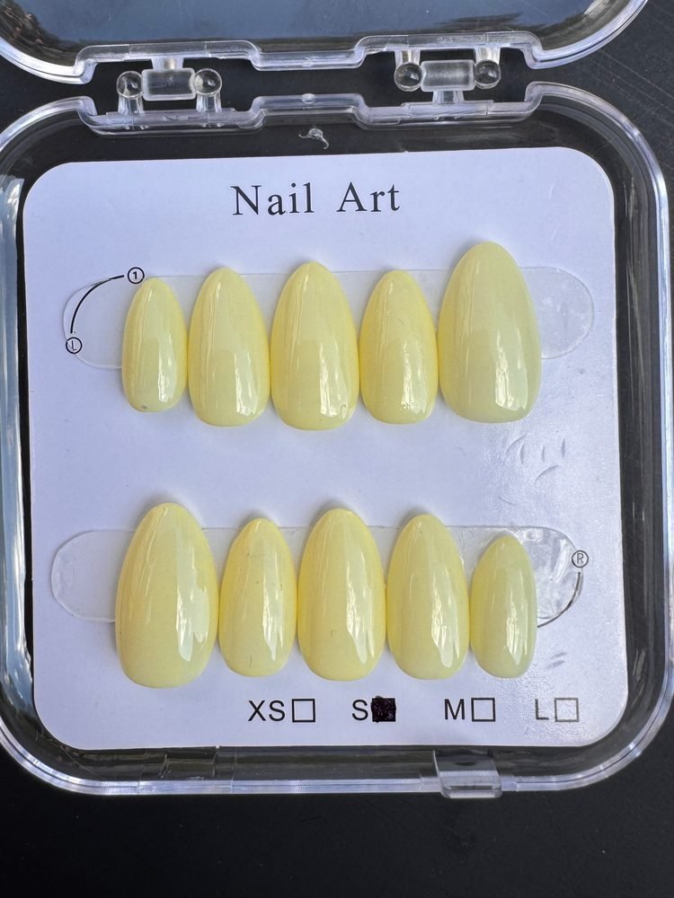 Buttercup Gloss press-on set — solid glossy pastel yellow almond nails, a great transition shade into fall
